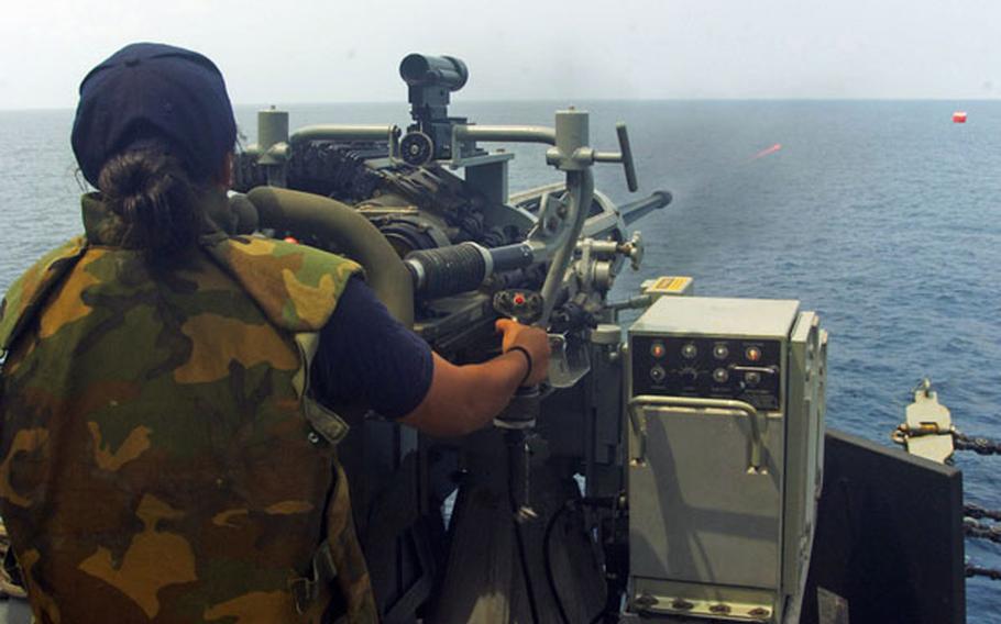 Petty Officer 3rd Class Yuritsie Aguilar-Arenas fires upon a "killer tomato" target aboard USS Howard during an exercise with Malaysia in the South China Sea on June 13. Recent incidents between Chinese vessels and other nations in the sea, which China claims most of as its sovereign territory, have led Southeast Asian nations to seek closer ties with the U.S. Navy.