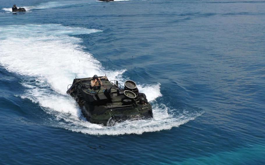 Amphibious assault vehicles approach the well deck of the USS Tortuga during an exercise with Malaysia in the South China Sea on June 12. Recent incidents between Chinese vessels and other nations in the sea, which China claims most of as its sovereign territory, have led Southeast Asian nations to seek closer ties with the U.S. Navy.