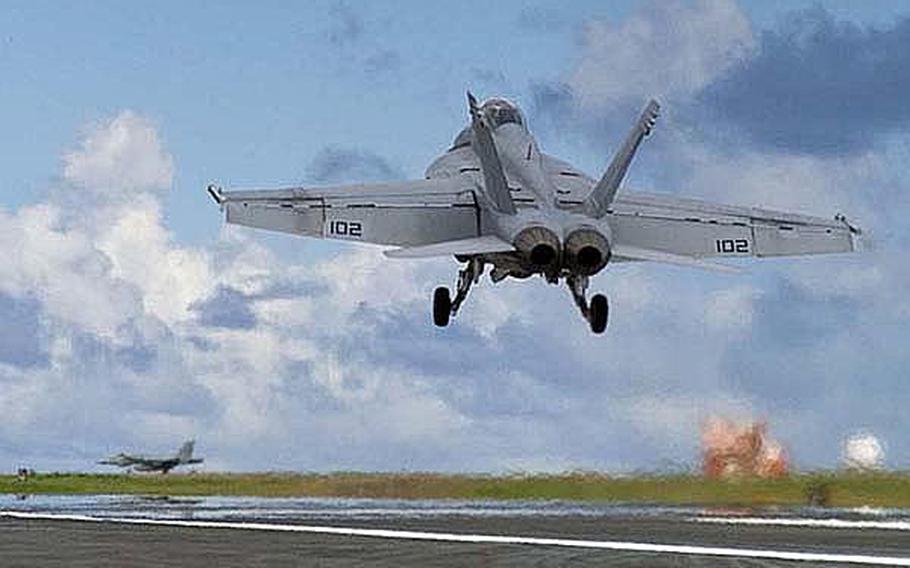 An FA-18/F Super Hornet assigned to Strike Fighter Squadron 102, performs touch-and-go flight operations on Iwo To in this 2007 file photo. The Japanese government has proposed moving the U.S. Navy&#39;s filight operations from Iwo To to Mageshima.