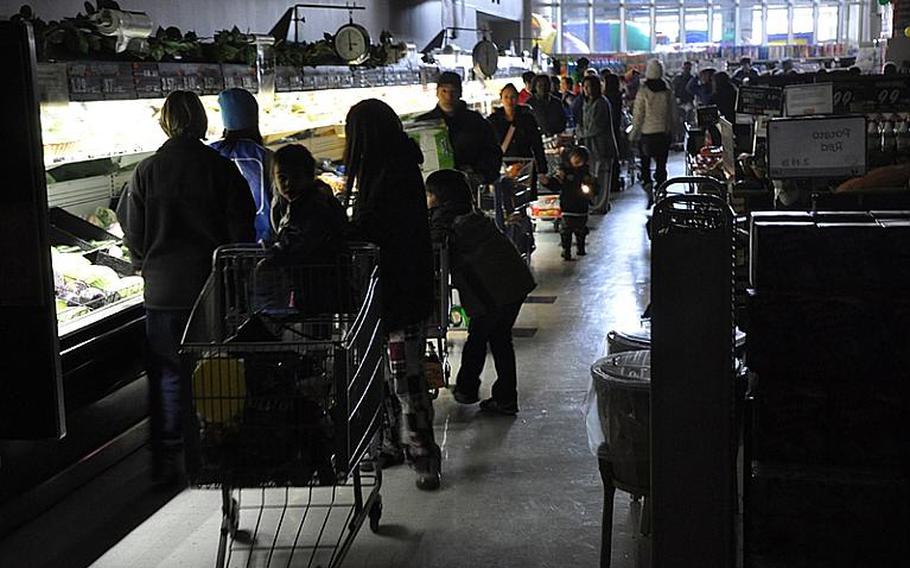 Hundreds of people crowd the Misawa Air Base commissary the morning after a magnitude-9.0 earthquake rocked the region March 11, quickly emptying the shelves of batteries, water, canned food, barbecue charcoal, bread and other items.