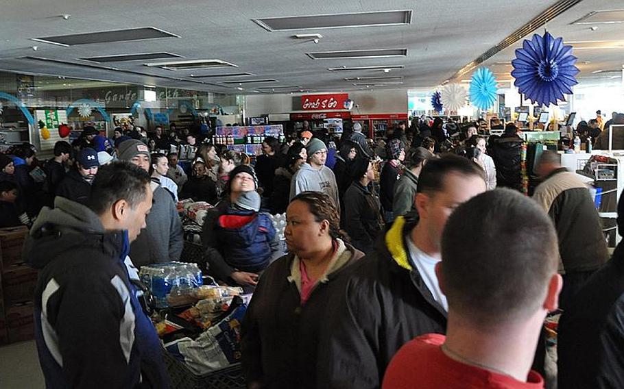 Hundreds of people crowd the Misawa Air Base commissary the day after the magnitude 9.0 earthquake rocked the region March 11, 2011, quickly emptying the shelves of batteries, water, canned food, barbecue charcoal, bread and other items.