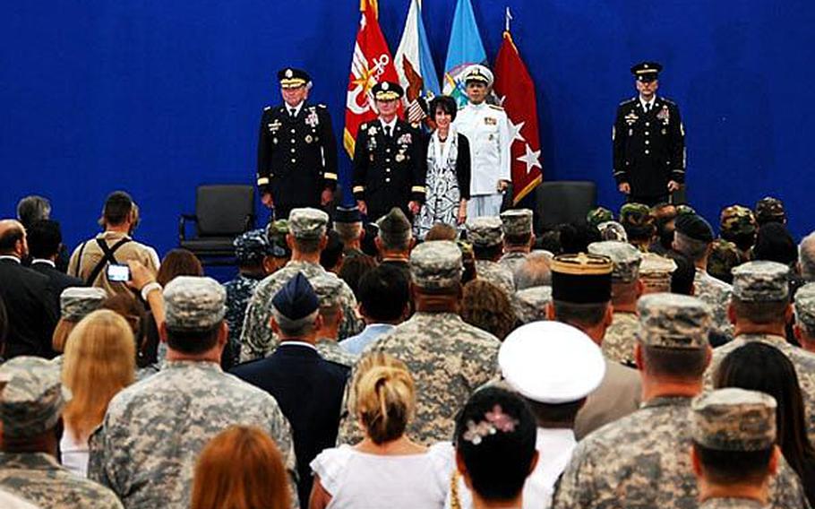 From left, Gen. James D. Thurman, Gen. Walter L. Sharp and Chairman of the Joint Chiefs of Staff Adm. Mike Mullen stand for pictures during a change-of-command ceremony July 14 at Collier Field House on Yongsan Garrison in South Korea.