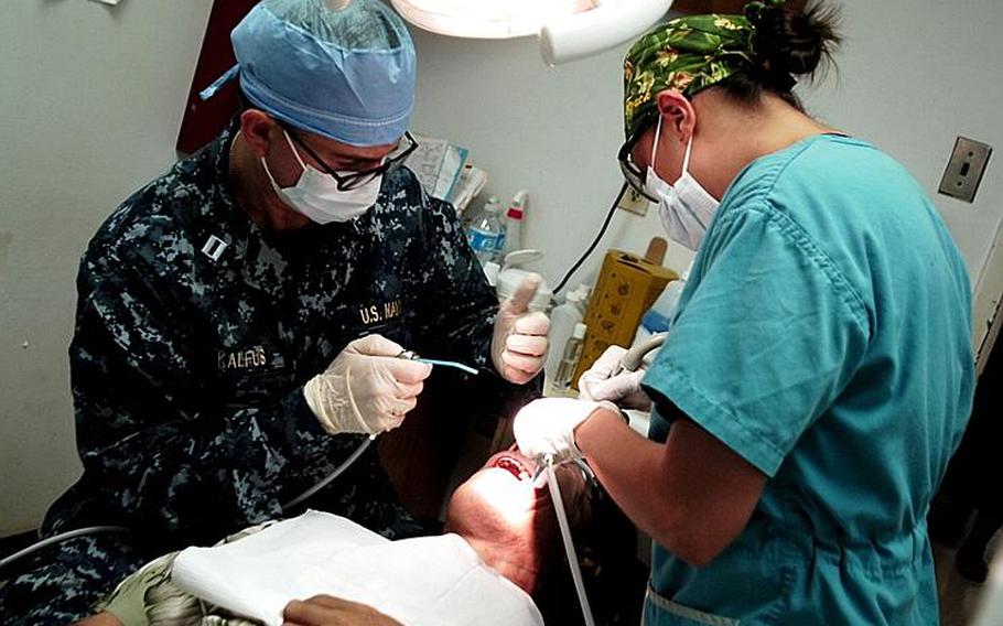 Lt. Arthur Kalfus, left, and Hospital Corpsman 3rd Class Celina Sweat perform dental procedures on the President of Micronesia, Manny Mori, during a medical civic action project at the Pohnpei State Department of Health Services as part of Pacific Partnership 2011. Pacific Partnership is a five-month humanitarian assistance initiative that will make port visits to Tonga, Vanuatu, Papua New Guinea, Timor Leste, and the Federated States of Micronesia.