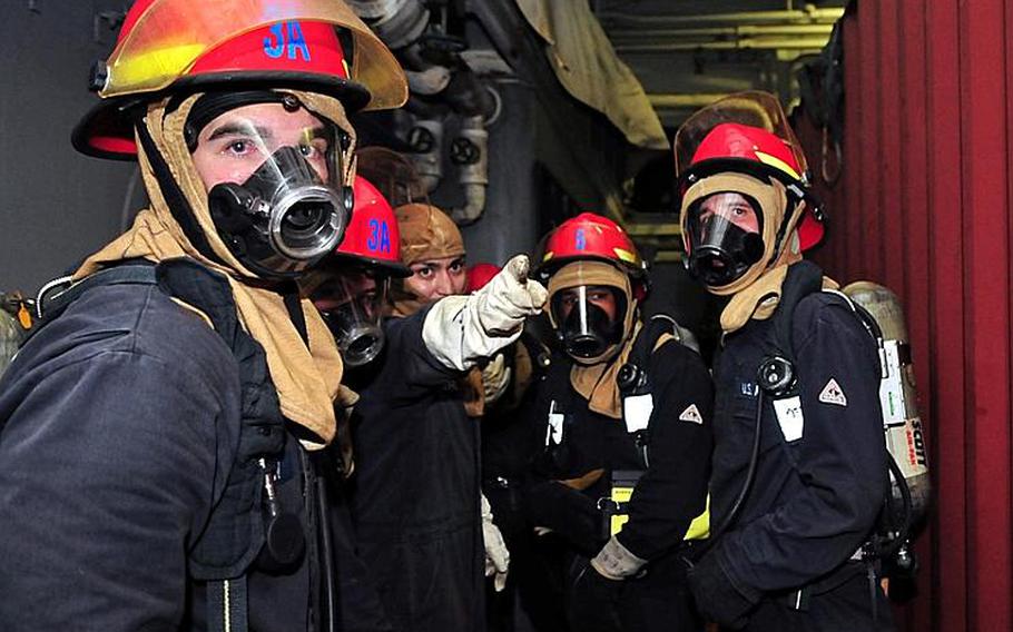 Sailors spot a fire during a fire drill aboard the amphibious transport dock ship USS Cleveland (LPD 7) while participating in Pacific Partnership 2011. Pacific Partnership is a five-month humanitarian assistance initiative that is making port visits to Tonga, Vanuatu, Papua New Guinea, Timor Leste, and the Federated States of Micronesia.