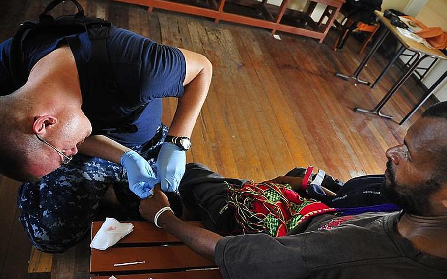 Hospital Corpsman 2nd Class Alan Kampert gives a Papua New Guinean man a malaria test during a Pacific Partnership 2011 medical civic action event. Pacific Partnership 2011 is a five-month humanitarian assistance initiative that will make port visits to Tonga, Vanuatu, Papua New Guinea, Timor-Leste, and the Federated States of Micronesia.