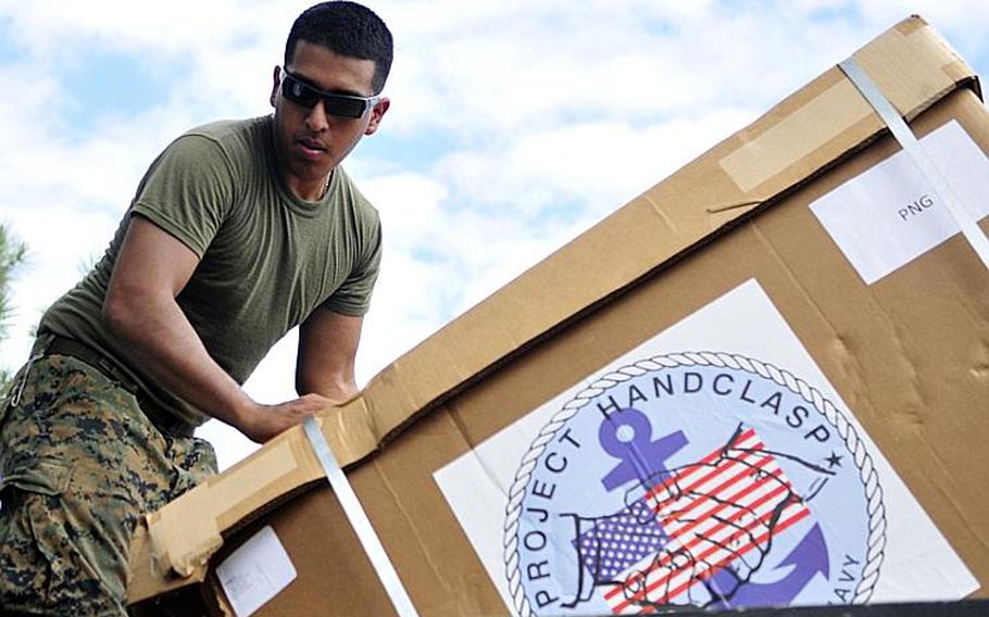Lance Cpl. Alonzo Aguilera, assigned to the amphibious transport dock ship USS Cleveland (LPD 7), moves educational supplies during a Pacific Partnership 2011 civic action project. Pacific Partnership is a five-month humanitarian assistance initiative that completed its mission in Tonga and Vanuatu, and will visit Papua New Guinea, Timor Leste, and the Federated States of Micronesia.
