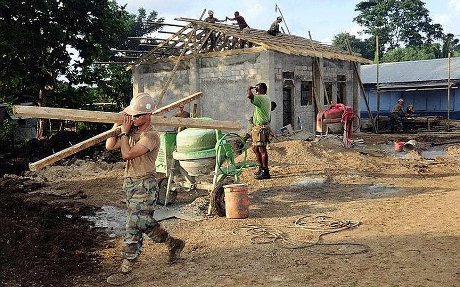 Seabees assigned to Naval Mobile Construction Battalion 133 and Vanuatu citizens work at an engineering civil action project during the Vanuatu phase of Pacific Partnership 2011. Pacific Partnership is a five-month humanitarian assistance initiative that will make port visits to Tonga, Vanuatu, Papua New Guinea, Timor-Leste and the Federated States of Micronesia.