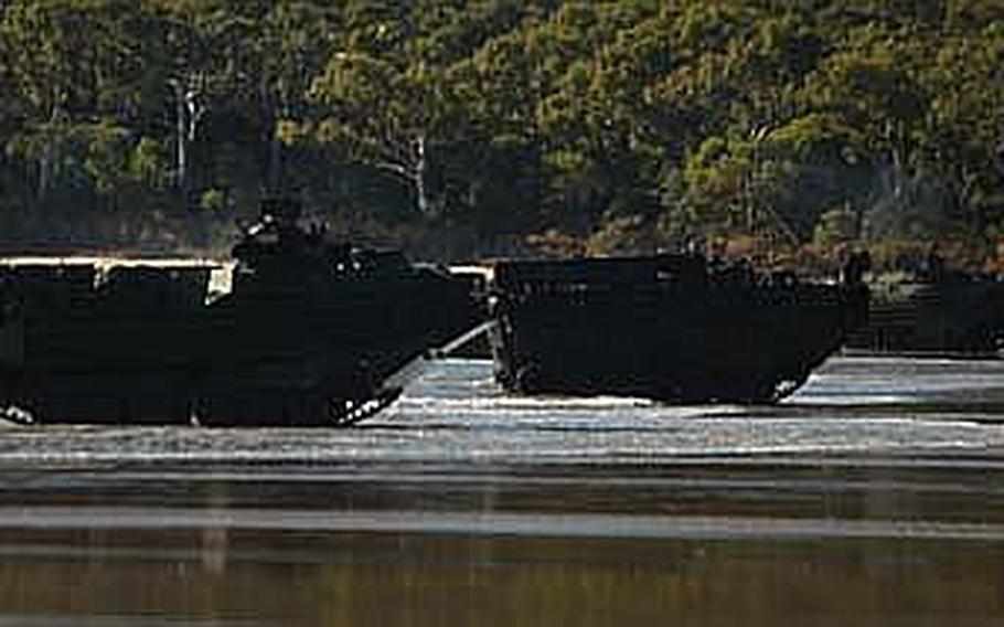 Amphibious assault vehicles carrying U.S. Marines secure Freshwater Beach during an amphibious assault exercise in Australia. One of the biggest and most comprehensive operations of the ongoing exercise, the amphibious assault featured a beach assault and airfield seizure with real world obstacles, including everything from enemy ambushes to simulated IED blasts.