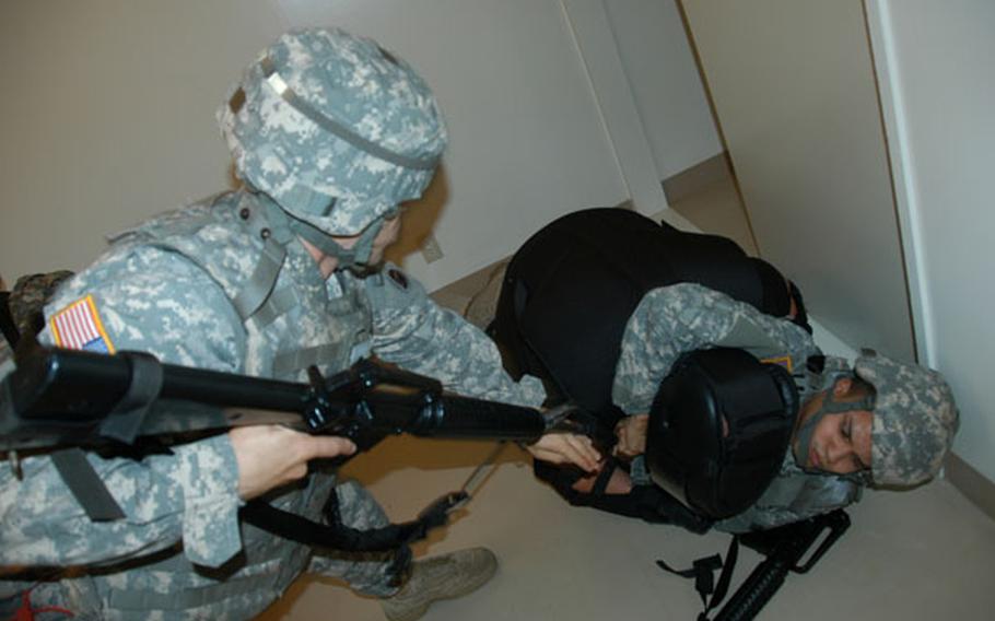 Two soldiers attempt to subdue an instructor posing as an insurgent during Army Combatives Level II training at Camp Zama on July 19, 2011.