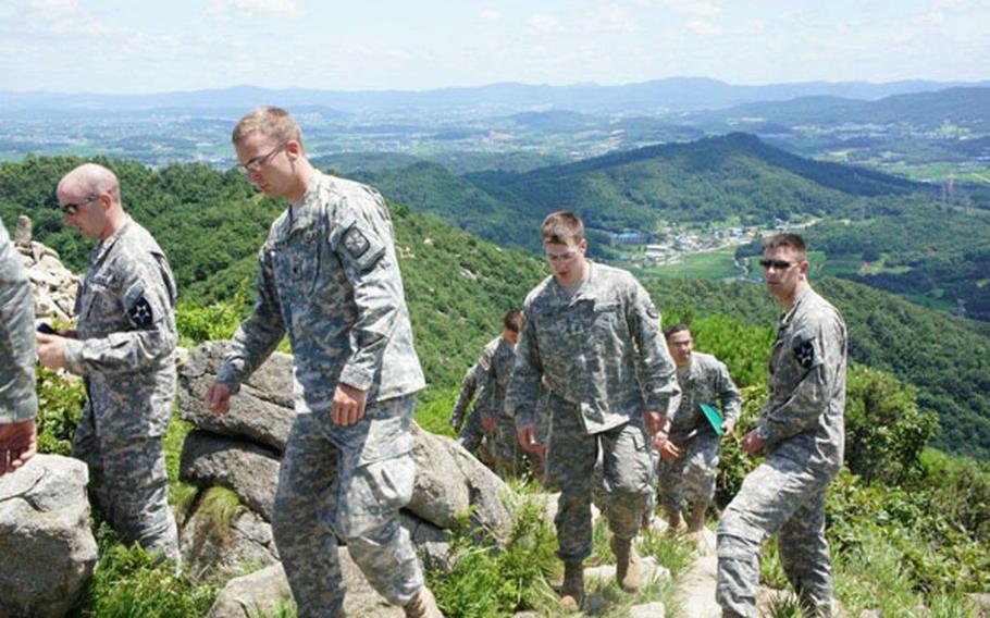 Cadets from ROTC programs at a number of American colleges tour a South Korean mountain on July 19. The cadets are in South Korea as part of a monthlong Cadet Troop Leadership Training program that exposes them to U.S. Army life, and during which they are put in charge of a platoon.