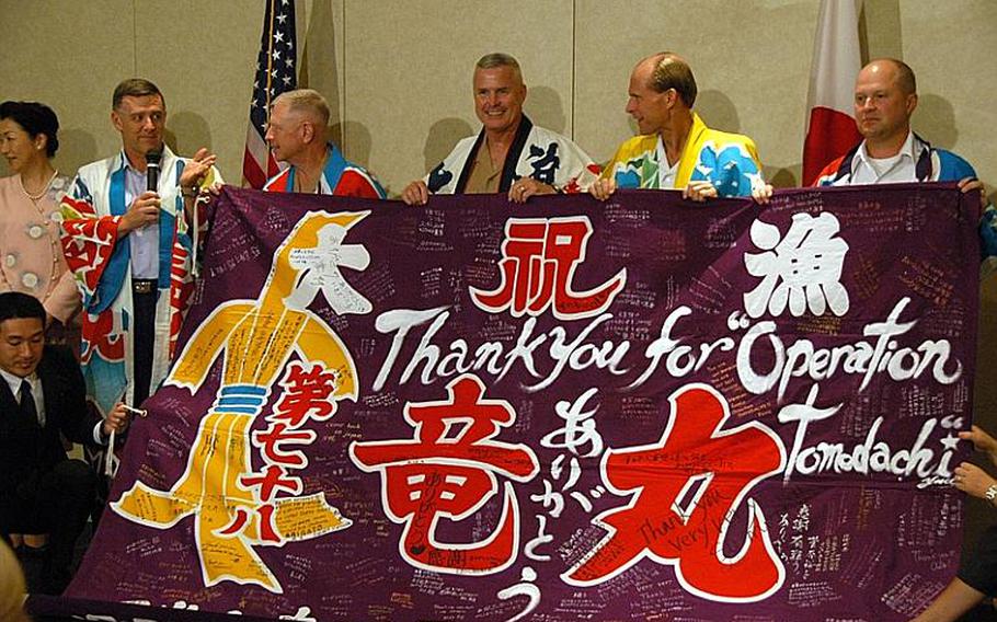 Japanese residents of Miyagi Prefecture presented U.S. Forces Japan leaders with "happy coats" and a "tairyo-bata" flag in Tokyo on Monday to thank them for Operation Tomodachi. The U.S. leaders, left to right in happy coats, included U.S. Forces Japan commander Lt. Gen. Burton Field, III Marine Expeditionary Force Commander Lt. Gen. Kenneth J. Glueck Jr., Deputy USFJ commander Brig. Gen. William B. Crowe, U.S. Naval Forces Japan commander Rear Admiral Dan Cloyd and U.S. Army Garrison Japan commander Col. Eric D. Tilley.