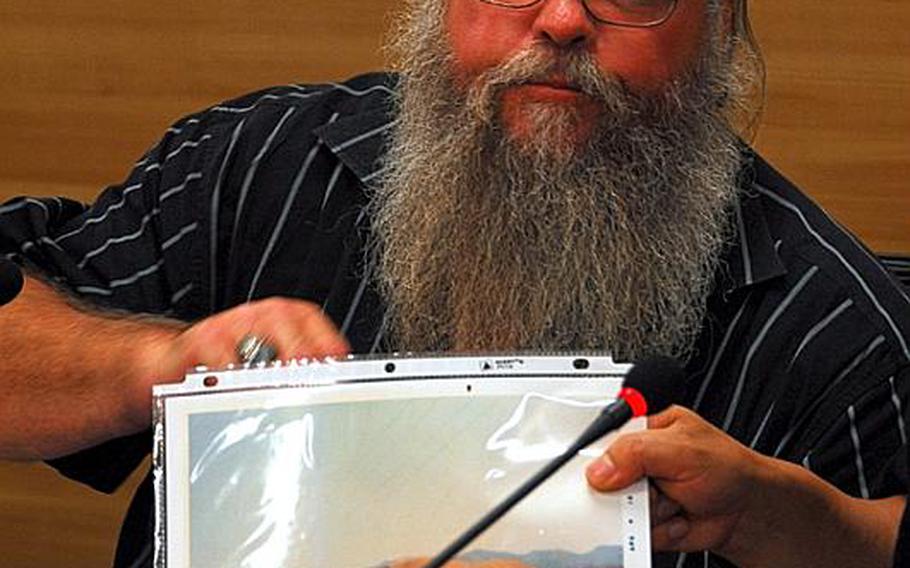 Steve House, a veteran formerly stationed at Camp Carroll, displays a photo of an area on the base where he says he helped bury barrels of Agent Orange in 1978. House testified before members of South Korea&#39;s National Assembly on Monday, along with veteran Phil Steward, who claims troops sprayed the toxic defoliant at bases in the late 1960s.
