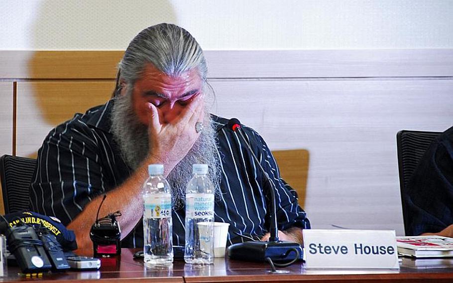 Veteran Steve House wipes away tears after asking South Korean lawmakers to pressure the U.S. military to admit it buried Agent Orange at Camp Carroll in 1978. House, who said he buried the defoliant while stationed at Carroll, testified before the National Assembly along with a second U.S. veteran who said Agent Orange was widely sprayed throughout the country in the 1960s and 1970s.