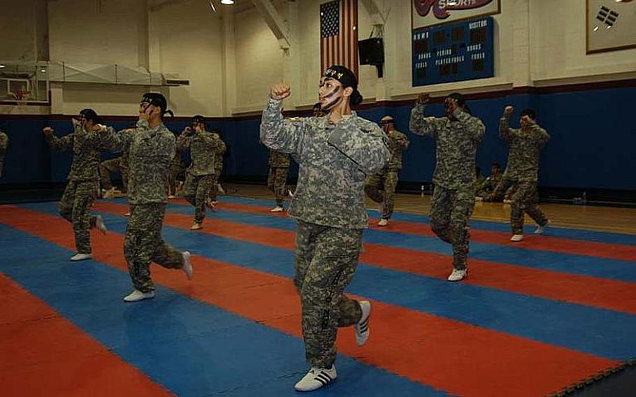 Pfc. Arianna Rendon, center, and the rest of the 2nd Infantry Division Tae Kwon Do Demonstration Team show off some moves Aug. 3, 2011, during a performance at Camp Red Cloud in South Korea.