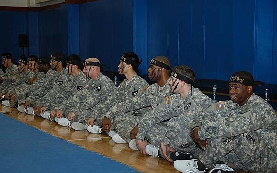 Members of the 2nd Infantry Division's Tae Kwon Do Demonstration Team wait their turn during a performance Aug. 3, 2011, at Camp Red Cloud in South Korea.