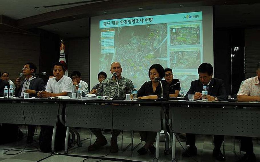 Col. Joseph Birchmeier, center, listens as a reporter asks a question during a press conference at the Chilgok County Office about the U.S. military's alleged burial of Agent Orange at Camp Carroll, South Korea, in 1978. A U.S.-South Korean investigation team said Friday that it has found no evidence that the defoliant was buried at Carroll, as alleged by a group of veterans.