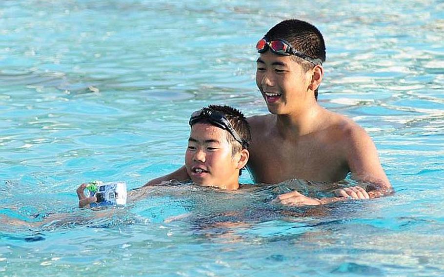 Children from Oshima District, Kesennuma City, Miyagi Prefecture play in the pool on Camp Foster. Twenty-five children from Oshima as well as five chaperones visited Okinawa as part of a four-day cultural exchange/homestay program sponsored by Marine Corps Base, Japan.