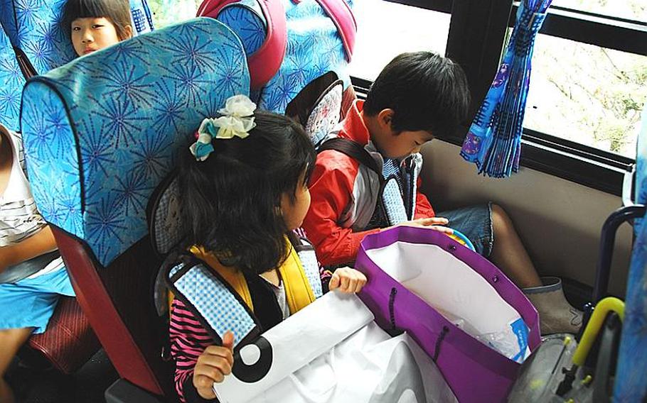 Taesongdong students wait on a school bus to leave the village at the end of the day. Most Taesongdong students live outside the village in neighboring Paju or Munsan.