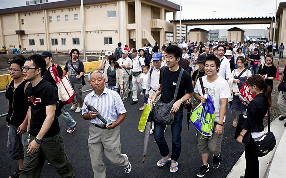 Massive crowds filed through the supply gate at Yokota Air Base, Japan, on Aug. 20, 2011, for the base's annual Japanese-American Friendship Festival. The two-day event was expected to draw more than 100,000 visitors, according to Yokota officials.