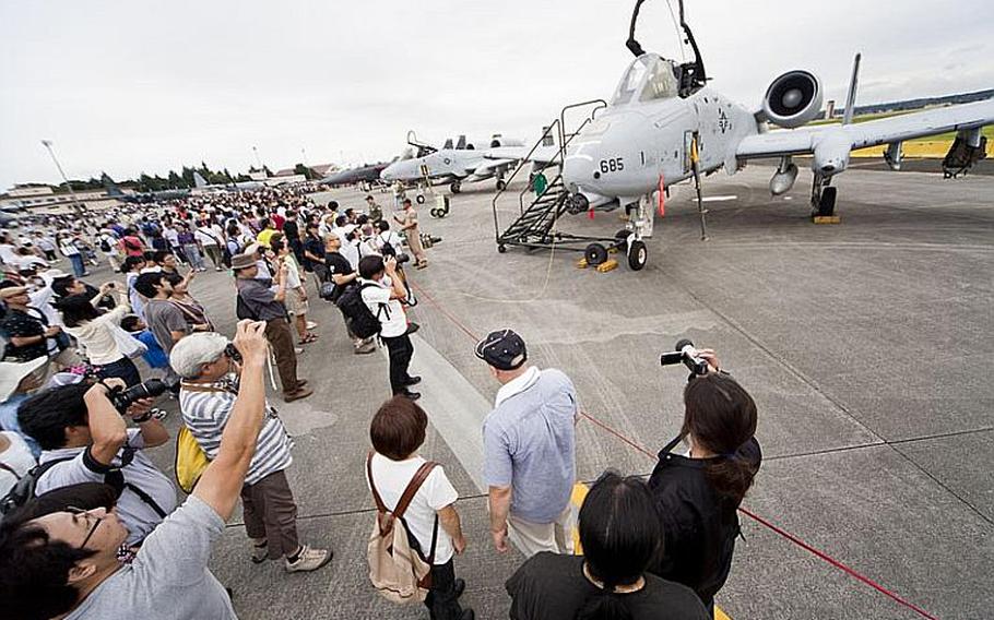 Visitors gather to take photos in front of the A-10 Thunderbolt, one of the many aircraft on display Aug. 20, 2011, for the annual Japanese-American Friendship Festival at Yokota Air Base, Japan.