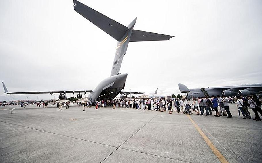 Visitors wait to take a tour inside the C-17 transport aircraft on display Aug. 20, 2011, at Yokota Air Base, Japan.