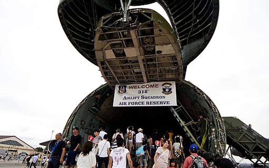 Visitors take a tour inside the C-5 Galaxy transport aircraft on display Aug. 20, 2011, at Yokota Air Base, Japan.