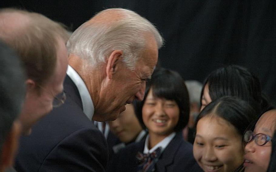 U.S. Vice President Joe Biden talks to Japanese schoolgirls at Sendai Airport on Tuesday. The students were scheduled to visit Biden's home state of Delaware on March 12 but the trip was cancelled after Japan was hit by a massive earthquake and tsunami on March 11.