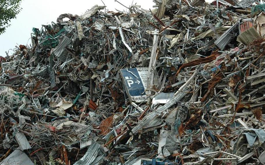 Piles of twisted metal and a field full of wrecked cars still greet people arriving at Sendai Airport but the camp that was home to soldiers and Marines and the stench from massive piles of rotting debris are long gone.