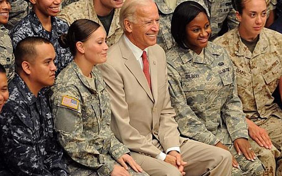 U.S. Vice President Joe Biden poses for a photo with the troops during his visit to Yokota Air Base, Japan, Wednesday