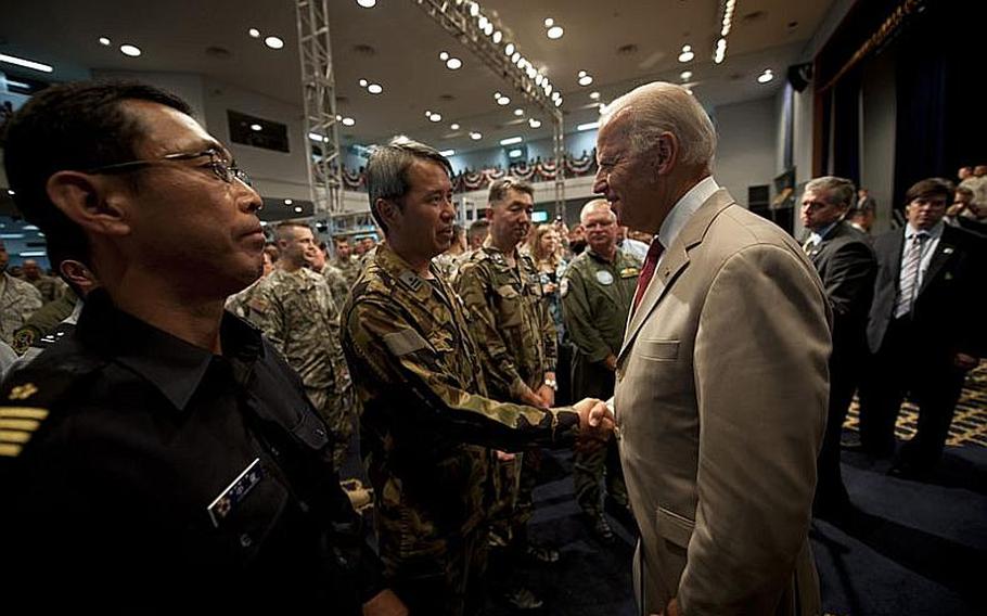 U.S. Vice President Joe Biden shakes hands with members of the Japan Self-Defense Force during his visit to Yokota Air Base, Japan, on Wednesday.