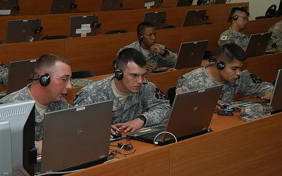 Soldiers with the 2nd Battalion, 9th Infantry Regiment focus on their laptop screens during a video game-like training session at Camp Casey in South Korea in August 2011.