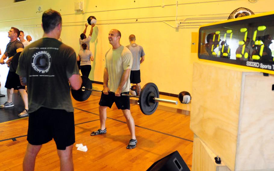 Air Force Capt. Nathan Dennen at the end of the sumo deadlift high pull portion of Fight Gone Bad 6 held at the O&#39;Connor Gym Saturday. Fight Gone Bad is an annual event held at Crossfit affiliates all over the world with the main aim being raising money for charities.