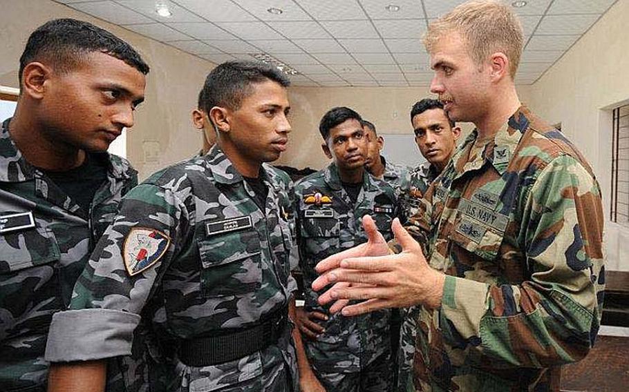 Engineman 2nd Class Benjamin Clemens (right), attached to Riverine Squadron (RIVRON) One, discuses riverine operations concepts with Bangladesh Navy sailors Monday during Cooperation Afloat Readiness and Training (CARAT) Bangladesh 2011. CARAT 2011 is a series of bilateral exercises held annually in Southeast Asia to strengthen relationships and enhance force readiness.