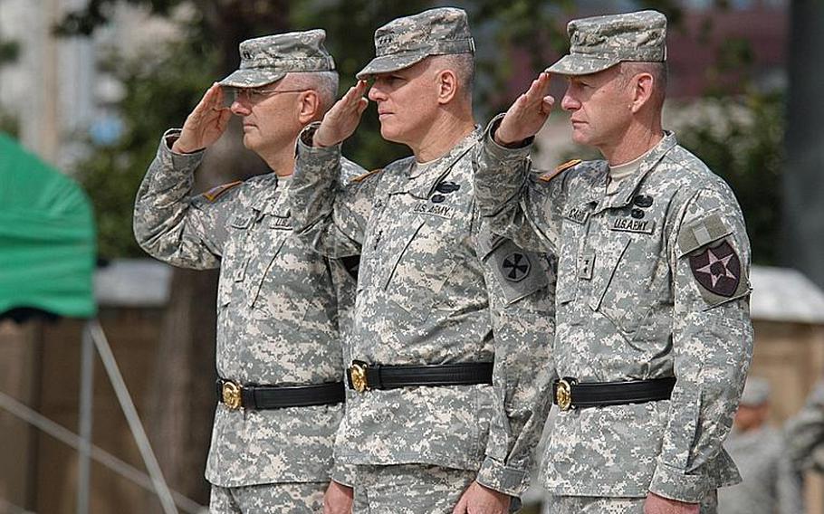 Maj. Gen. Michael Tucker, left, 8th Army commander Lt. Gen. John Johnson, center, and Maj. Gen. Edward Cardon, right, salute during the 2nd Infantry Division's change of command ceremony Tuesday at Camp Casey in South Korea. Cardon succeeded Tucker as commander of the division, most of which is stationed in the northernmost U.S. bases in South Korea.