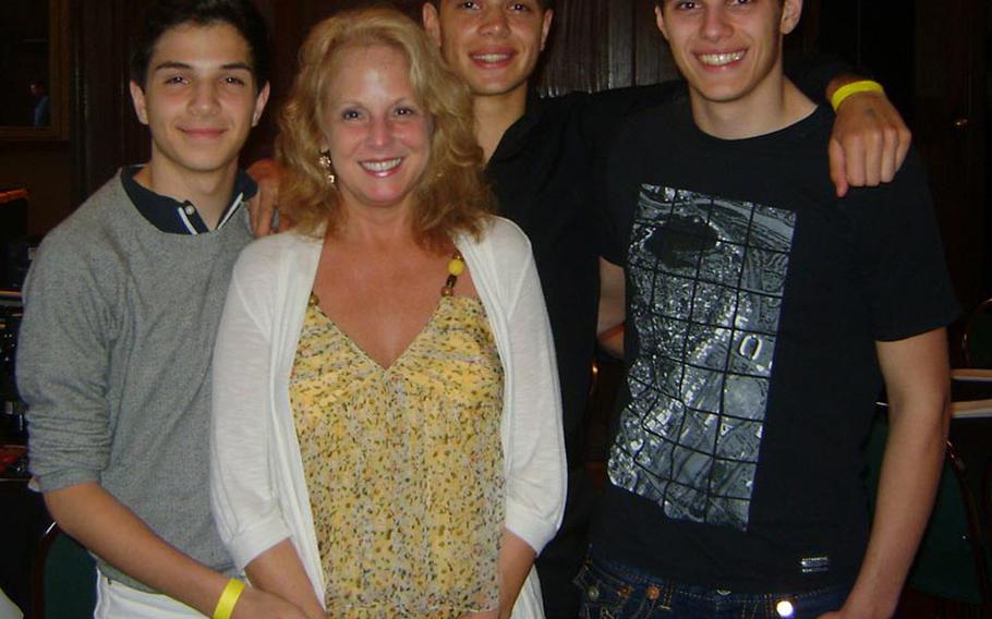 Americans Overseas Domestic Violence Crisis Center founder Paula Lucas, second from left, with her sons, left to right, Tariq, 17, Samer, 19, and Faris, 21.
