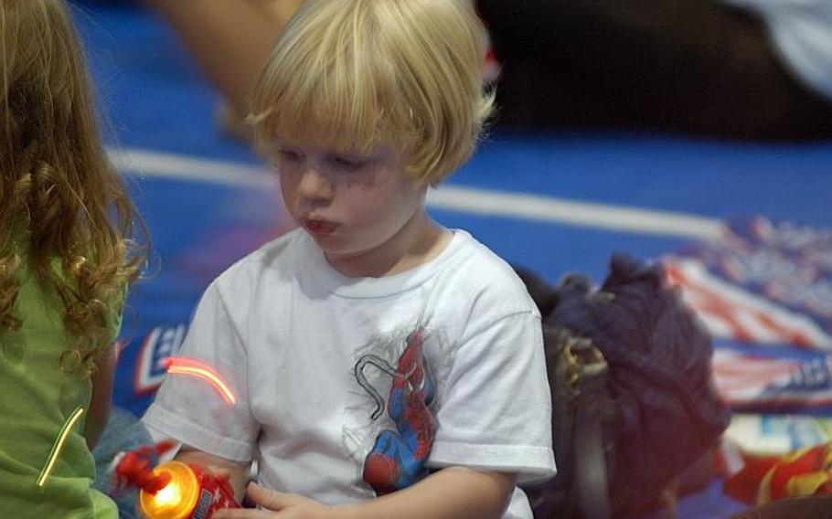 Three-year-old Jesse Brooks waits patiently for his favorite Sesame Street characters before the  Sesame Street/USO Experience for Military Families show Oct. 6, 2011, at Sasebo Naval Base, Japan.