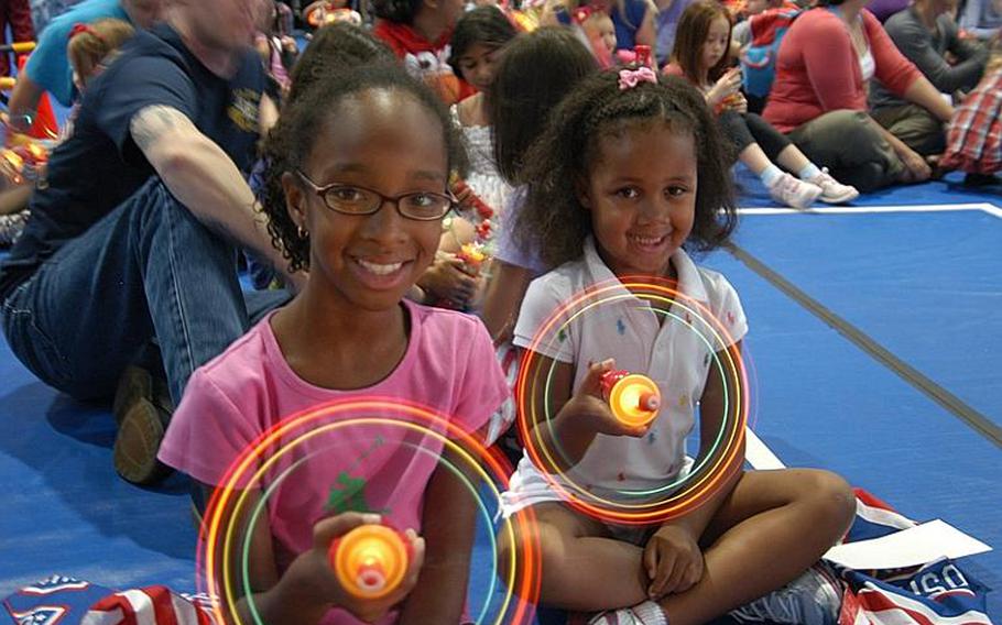 Arianna Rawles (left), 9, and her sister Joyah, 5, are all smiles prior to the Sesame Street/USO Experience for Military Families show Oct. 6, 2011, at Sasebo Naval Base, Japan.