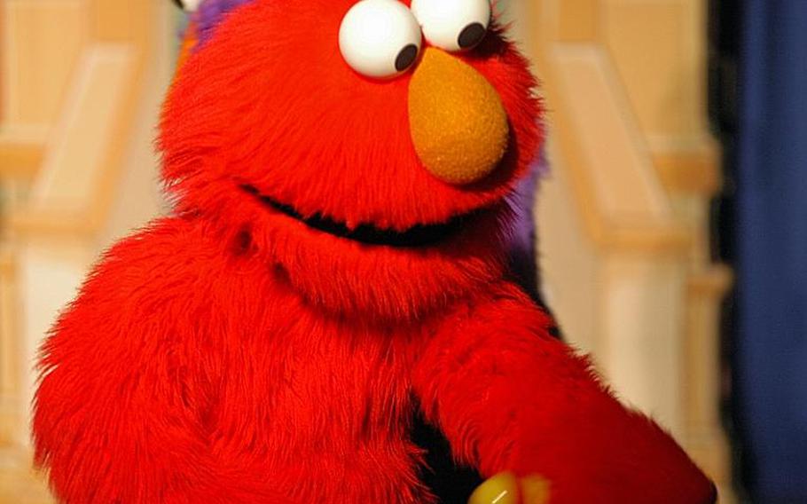 Elmo greets his legion of adoring fans in the audience following the Sesame Street/USO Experience for Military Families show Oct. 6, 2011, at Sasebo Naval Base, Japan.