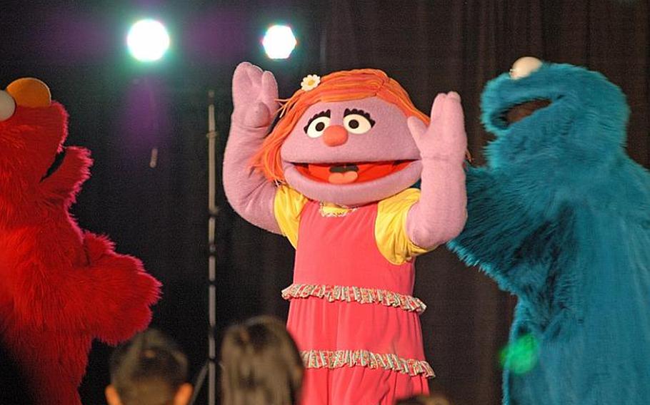Children stood in the front row, entranced by their favorite Sesame Street characters, during the Sesame Street/USO Experience for Military Families show Oct. 6, 2011, at Sasebo Naval Base, Japan.