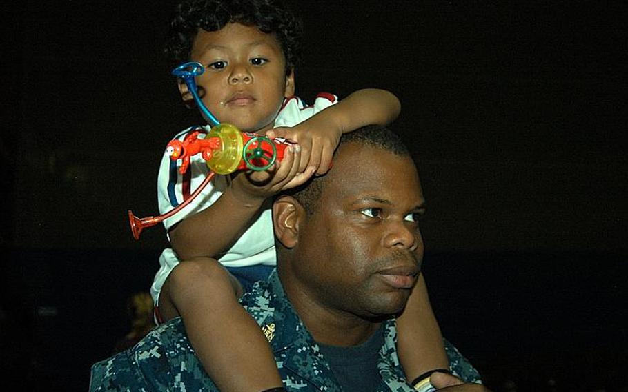 Joe Brown, 3, takes in a Sesame Street performance on the shoulders of his father, Chief Petty Officer Harvey Brown, on Oct. 6, 2011, at Sasebo Naval Base, Japan.
Matt Burke/Stars and Stripes