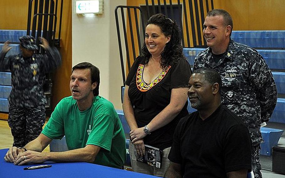 Susan and Ken Batten pose with Randy Johnson and Dennis Haysbert at the Yokosuka Fleet Recreation Center gym Oct. 11, 2011. Hundreds of fans converged on the gym to meet Johnson, a retired Major League Baseball star, and Haysbert, star of the TV show "The Unit." 
