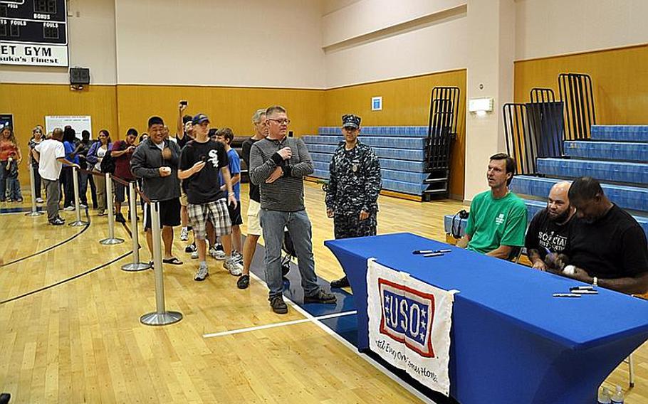 Fans line up to meet retired Major League star Randy Johnson and actor Dennis Haysbert at the Fleet Recreation Center gym at Yokosuka Naval Base, Japan, on Oct. 11, 2011. Hundreds of fans turned out to meet the stars and get an autograph.