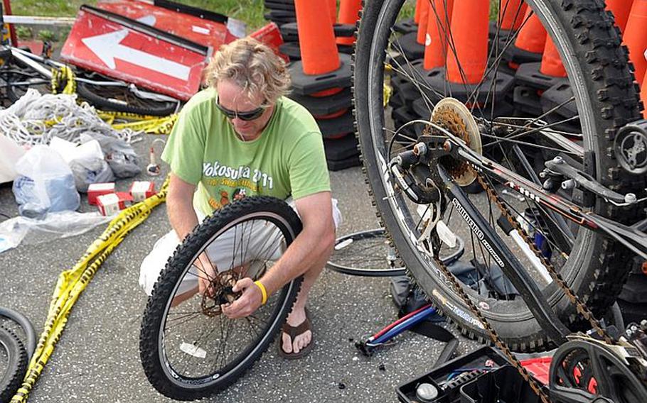 Ian Prickett, an MWR employee, spent his day repairing bicycles for people in need.