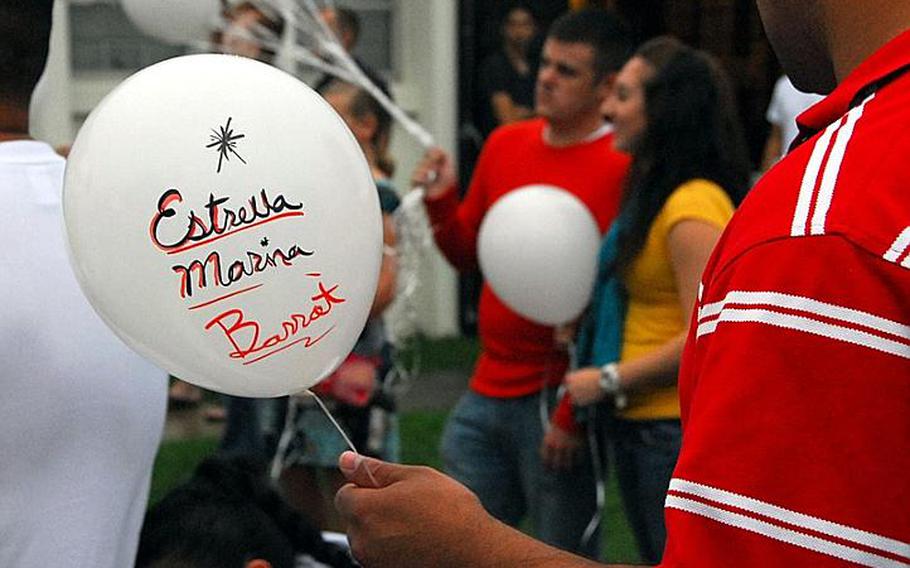 Marine Corps Chief Warrant Officer 2 Juan Barrot holds a balloon with the name of his daughter, Estrella, who passed away  soon after she was born in 2006. Barrott was one of dozens who took part in the 3rd annual Walk to remember service on Oct. 15, 2011, held at the chapel on Camp Lester.