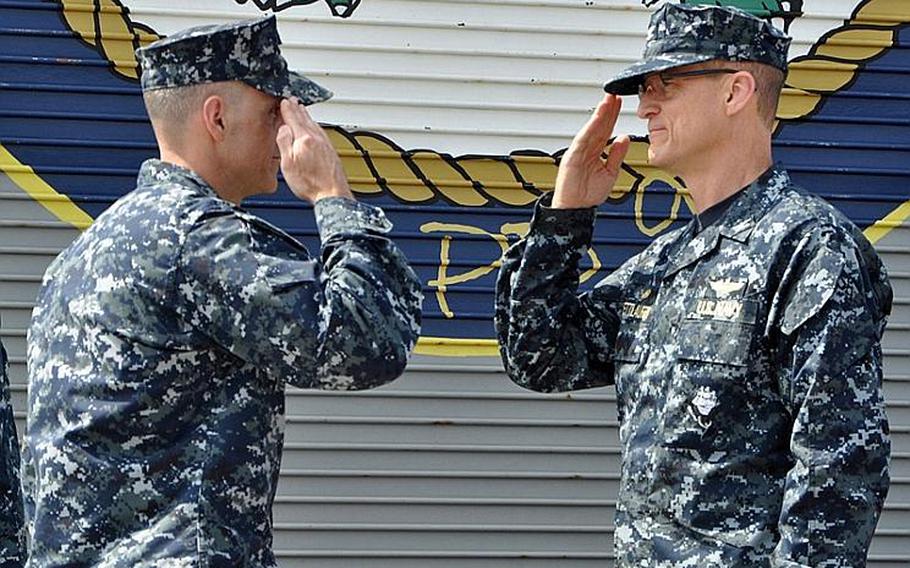 Capt. Michael Wettlaufer, right, relieves Capt. Mario Mifsud as commanding officer during a change of command ceremony Oct. 18, 2011, aboard the amphibious transport dock USS Denver. 