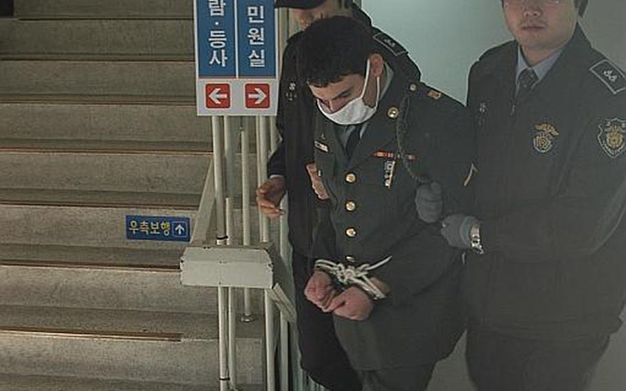 Pvt. Kevin Lee Flippin, 21, is led out of the Uijeongbu District Courthouse in South Korea after being sentenced Nov. 1, 2011, to 10 years in prison for the brutal Sept. 24 rape of a 17-year-old Korean girl.