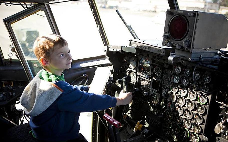 Dressed in his flight suit and ready to fly, Gunner Aflleje, a first-grader at Joan K. Mendel Elementary, gets behind the cockpit of a C-130 Nov. 2, 2011 at Yokota Air Base, Japan. Aflleje said he hopes to be a pilot like his grandfather. Mendel students were treated to a front row seat to various operations on the base.
