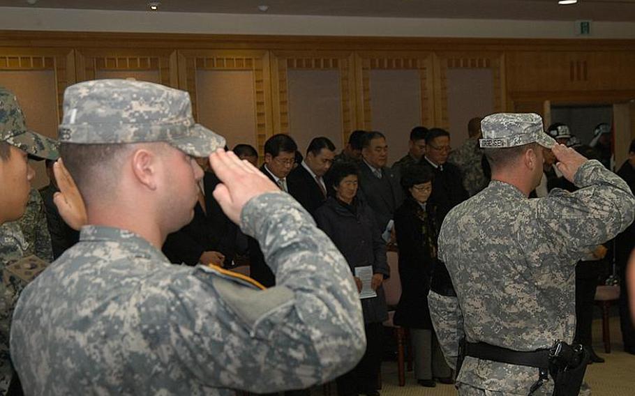 Family of Cpl. Jang Myung-ki, center, observe a moment of silence Nov. 23, 2011, during a ceremony at Korea's Demilitarized Zone marking the 27th anniversary of a firefight there in which Jang was killed.

