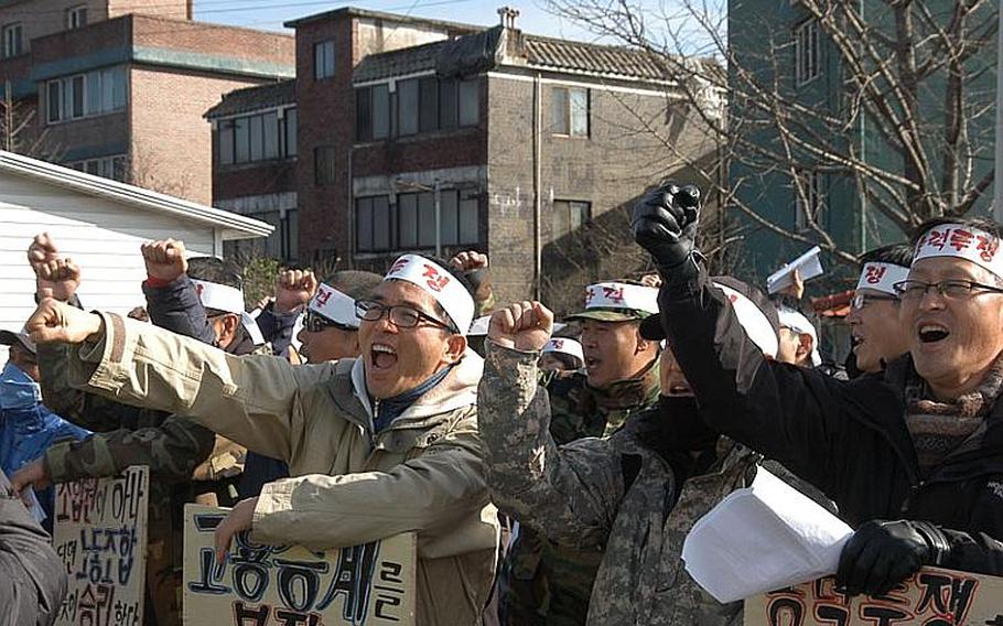 A group of about 50 security guards chant in protest Dec. 1, 2011, across the street from Camp Red Cloud in Uijeongbu. The guards are upset that the company that the week of Nov. 28 took over security for U.S. Army installations in South Korea will only hire them if they accept less pay and longer hours than they worked for the company that formally held the security contract.