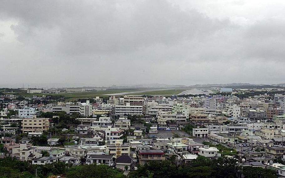 The southern end of the Futenma air station flight line sits adjacent to homes and businesses on Okinawa.